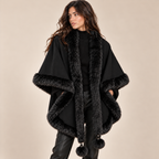 Faux Fur Trim Cape With Pom-Pom Ties in Black, model front view