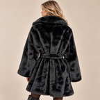 Belted Faux Fur Coat With Wide Lapels in Black, model back view